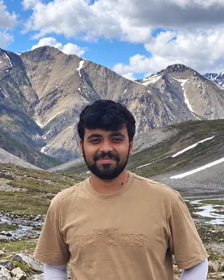 Aarav Pilania in an alpine valley, mountains behind him